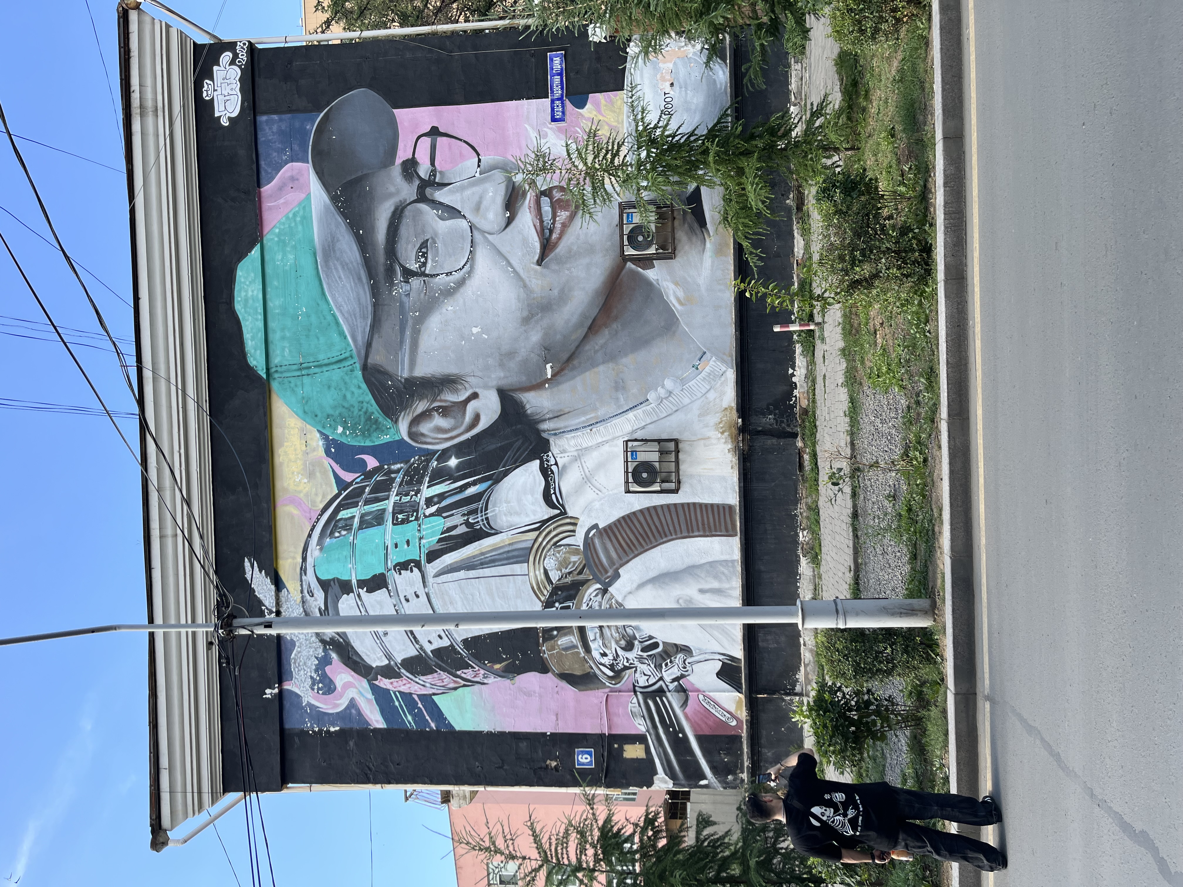 Street art mural of a figure on a building wall