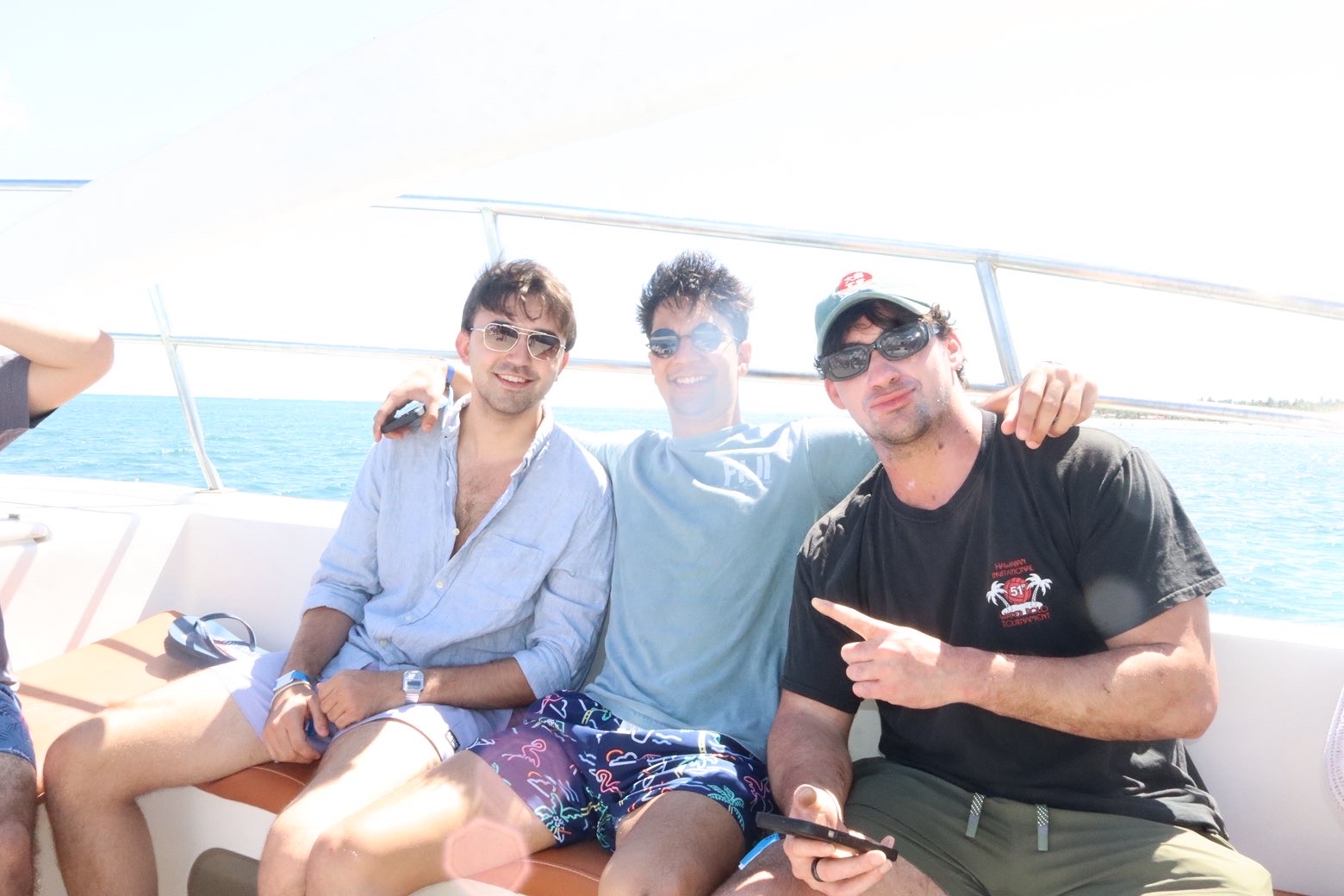 Three friends smiling on a boat