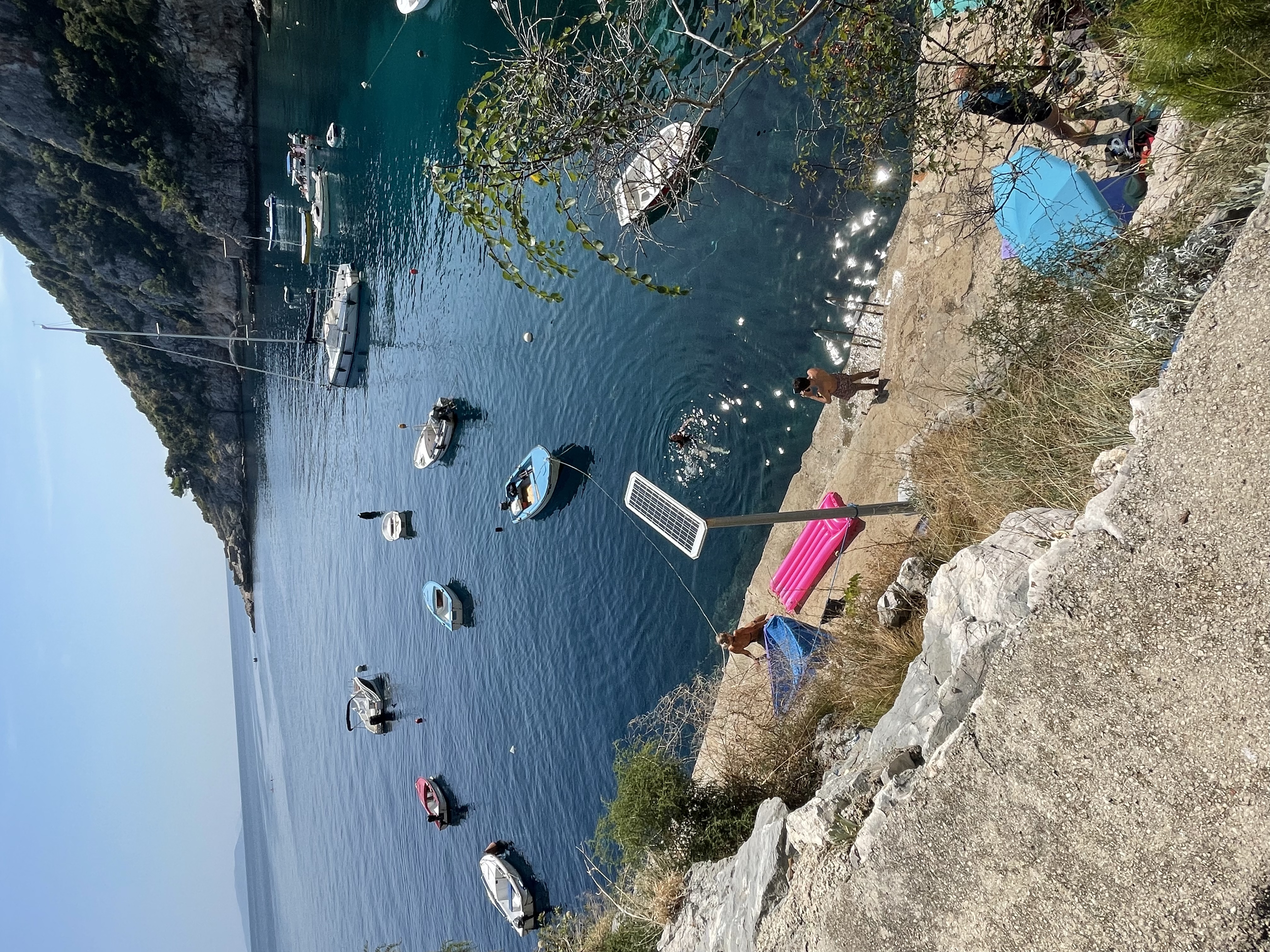 Overlooking a rocky cove full of small boats